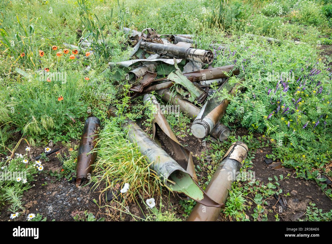Remnants of shells and rockets used by Russian forces against Ukraine collected by de-mining unit of National Guards of Ukraine ready for scrap removal seen in near Kherson in Ukraine on May 22, 2023 Stock Photo