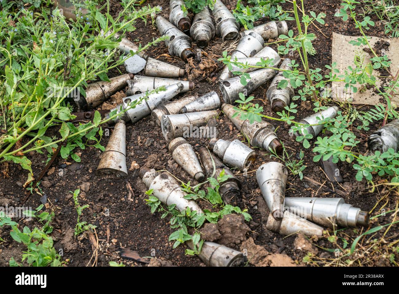 Remnants of fuzes of shells and rockets used by Russian forces against Ukraine collected by de-mining unit of National Guards of Ukraine ready for scrap removal seen in near Kherson in Ukraine on May 22, 2023 Stock Photo