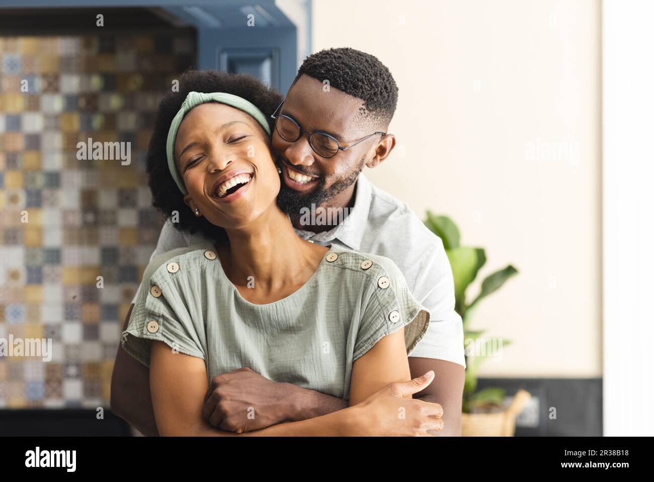 Portrait of happy african american couple embracing and laughing in ...
