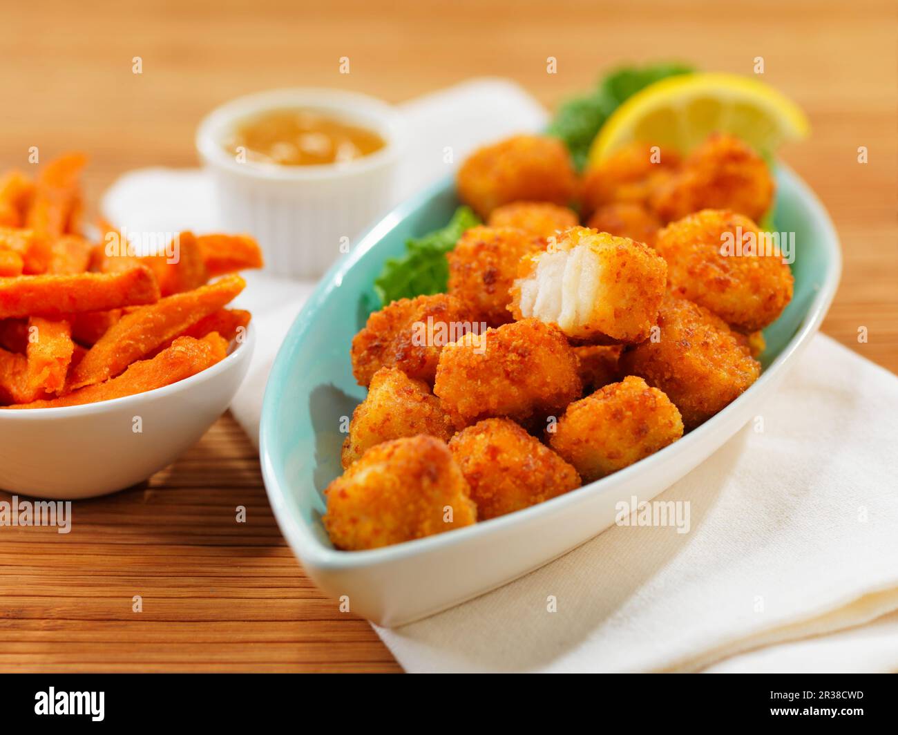 Fish nuggets with sweet potato fries Stock Photo Alamy