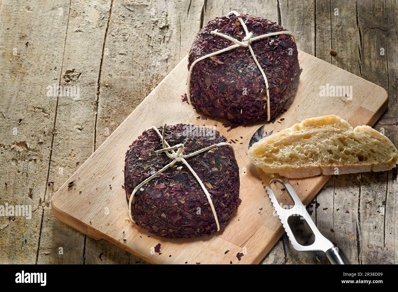 Pecorino with poppy seed rind on a wooden board Stock Photo