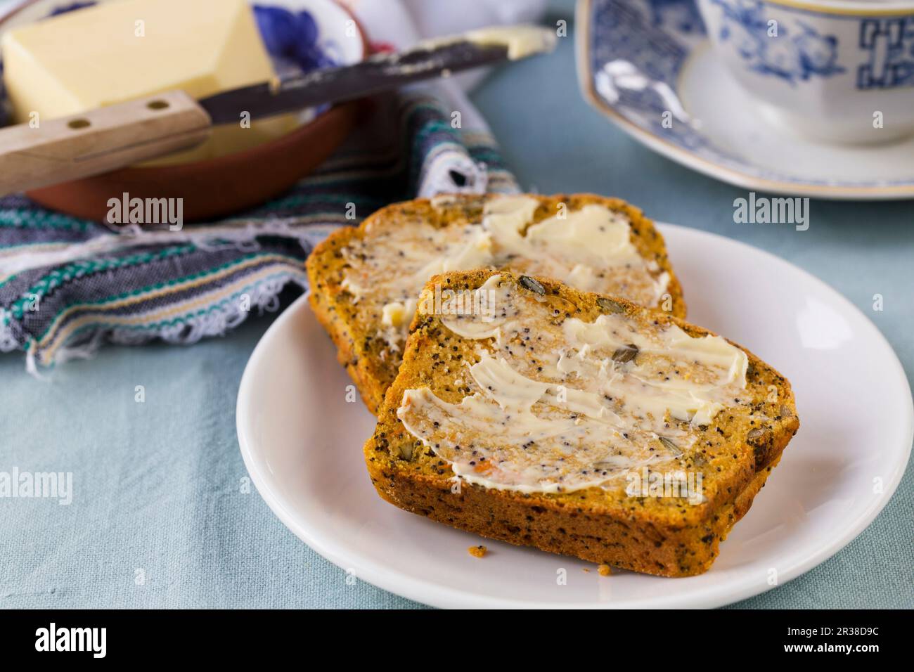 Two buttered slices of sweet potato bread with seeds and raisins Stock ...