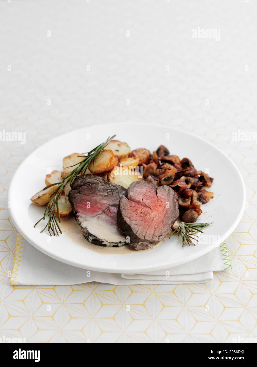 Beef fillets with fried potatoes and rosemary Stock Photo