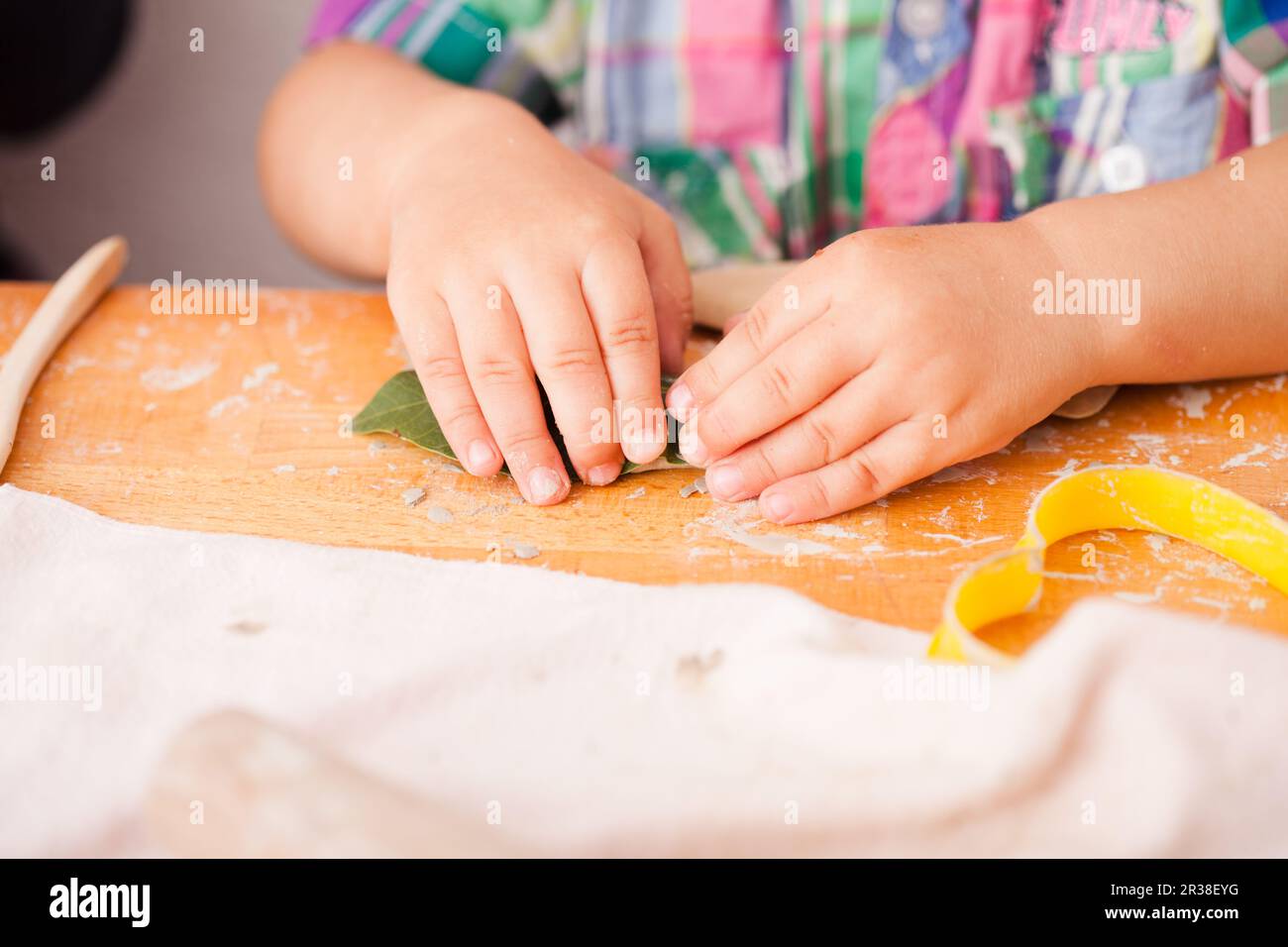 Happy children are engaged with modeling clay Stock Photo