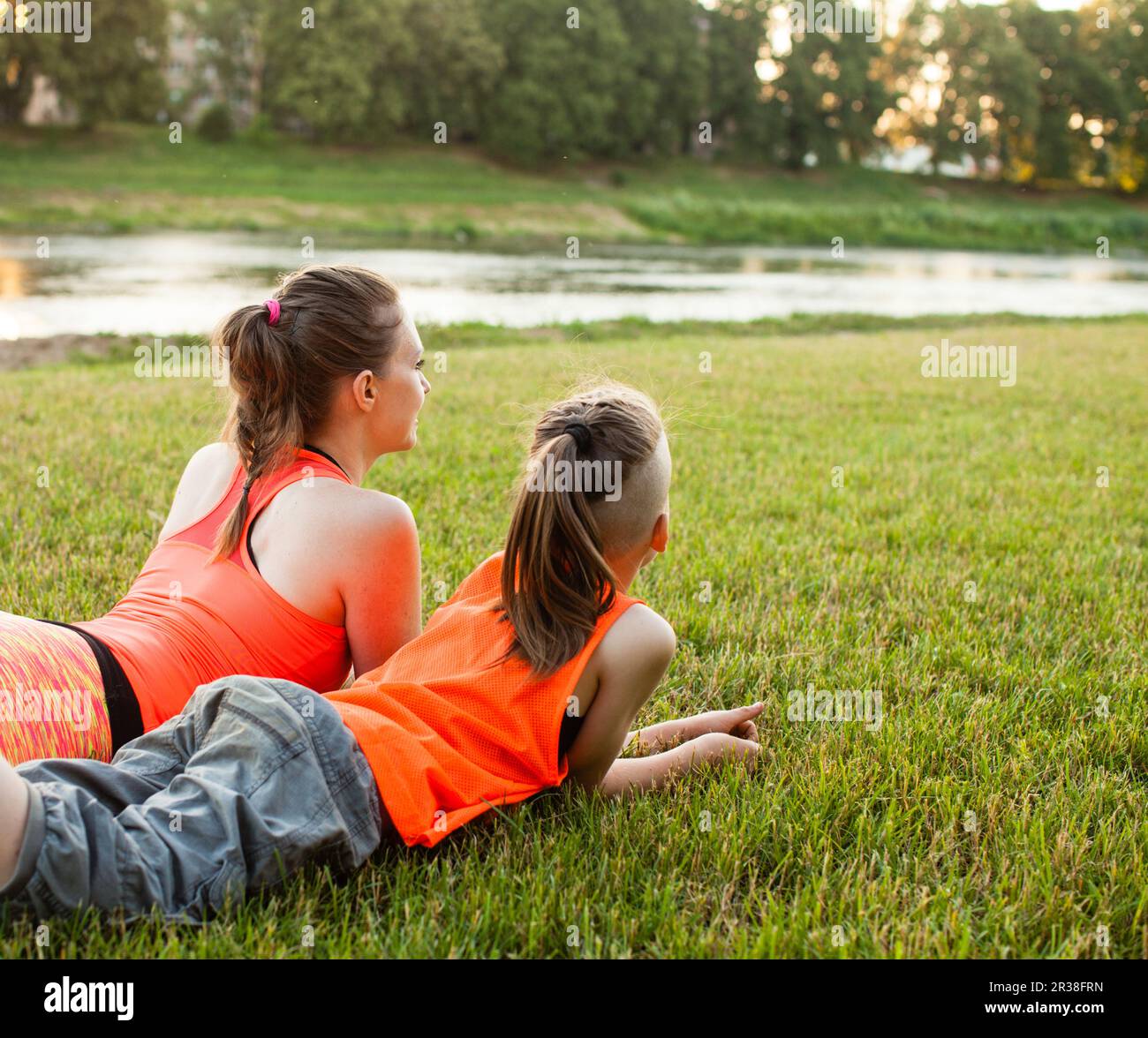Son and mother having rest on the grass Stock Photo - Alamy