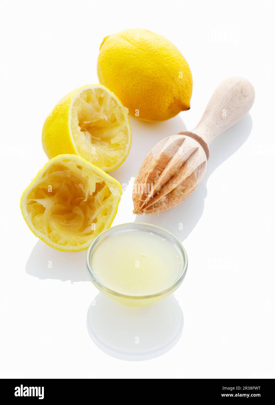 Lemon juice and a juiced lemon Stock Photo Alamy