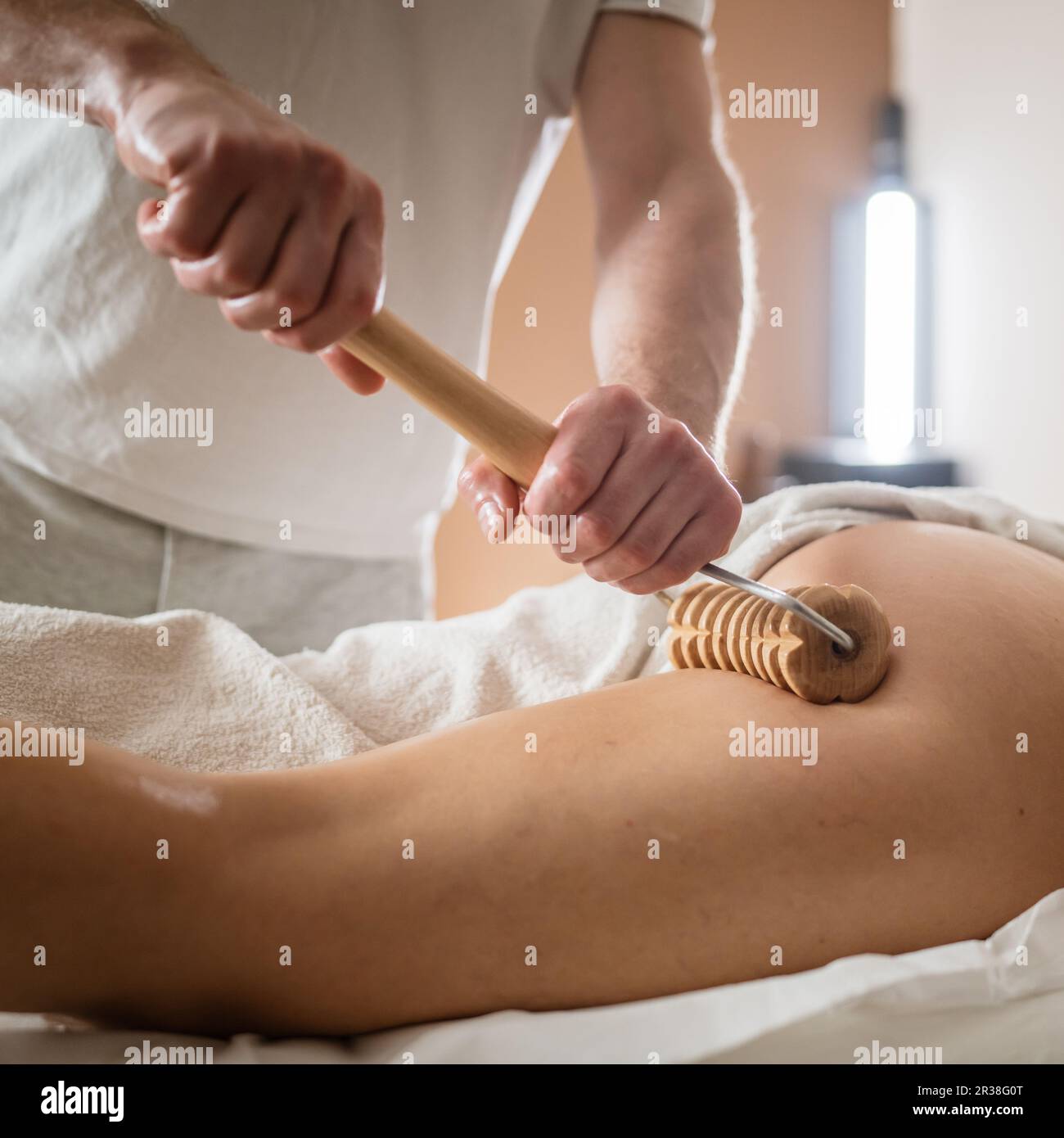 Unknown Caucasian woman having madero therapy massage anti-cellulite  treatment by professional therapist holding wooden tools in hands in studio  or sa Stock Photo - Alamy