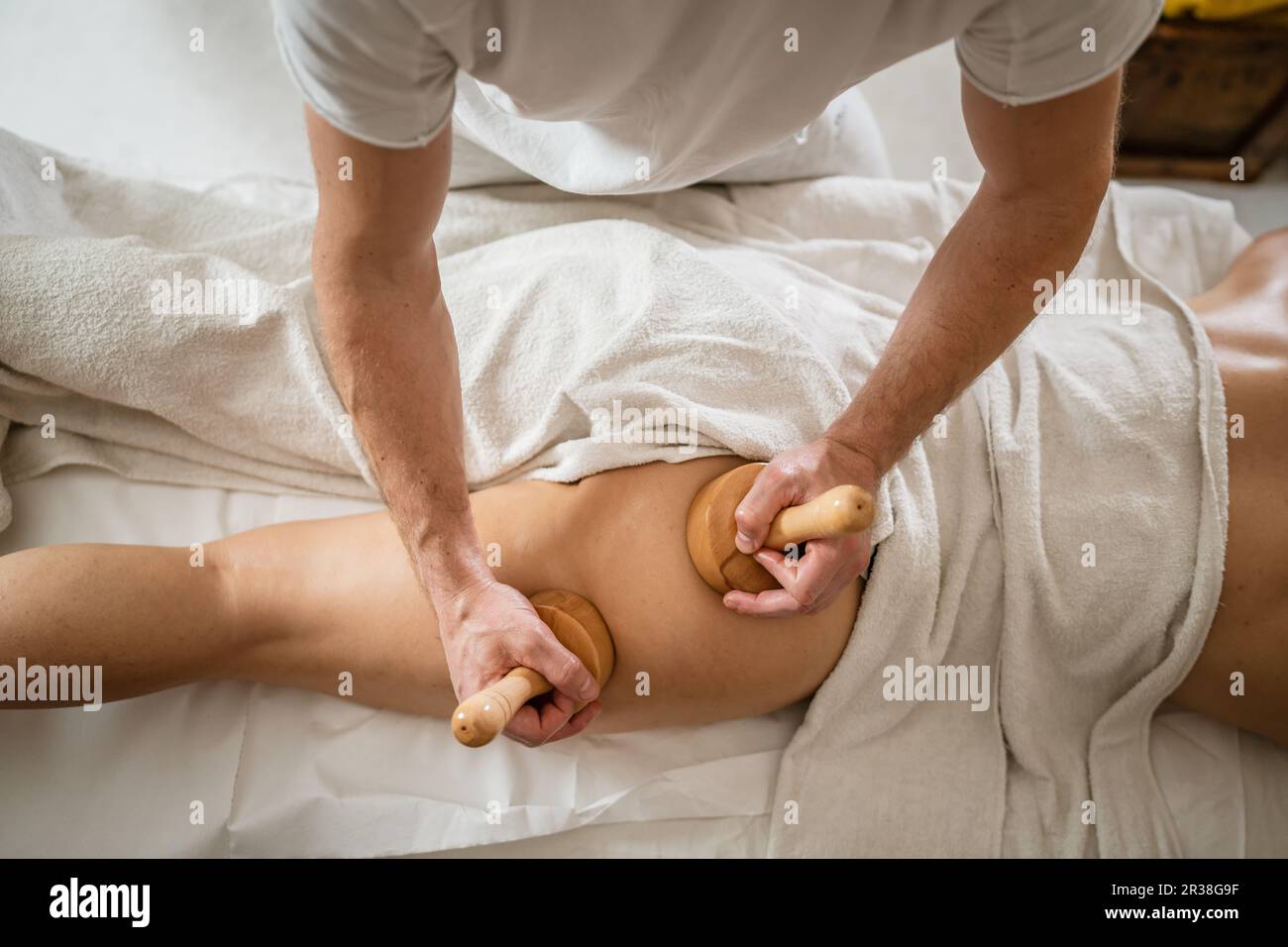 https://c8.alamy.com/comp/2R38G9F/unknown-caucasian-woman-having-madero-therapy-massage-anti-cellulite-treatment-by-professional-therapist-holding-wooden-tools-in-hands-in-studio-or-sa-2R38G9F.jpg