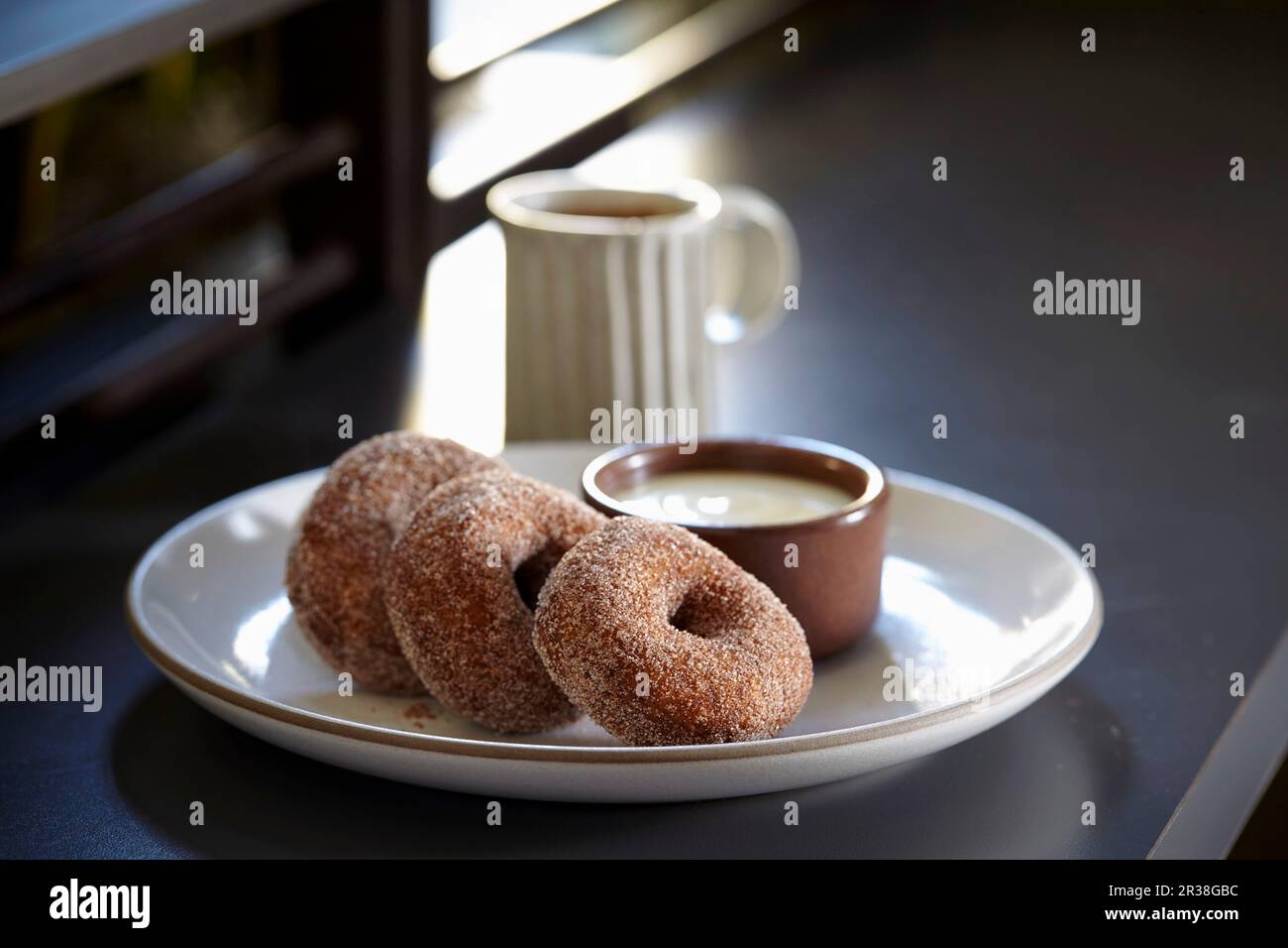 Buckwheat doughnuts with creme anglaise and coffee Stock Photo