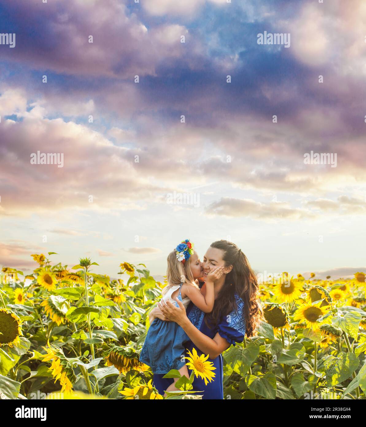 Mom and daughter among sunflowers Stock Photo Alamy