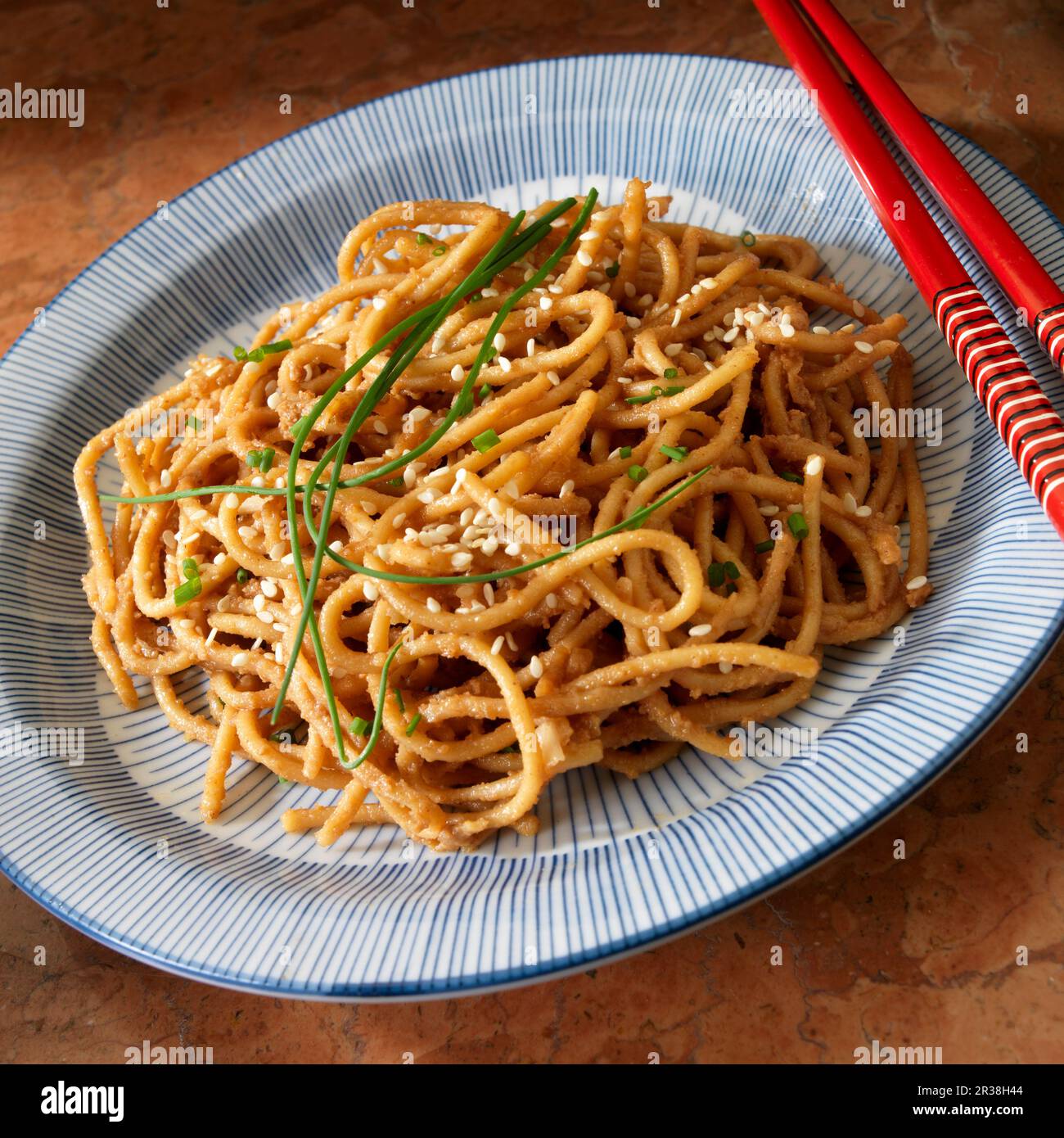 Sesame Peanut noodles with chive garnish Stock Photo Alamy