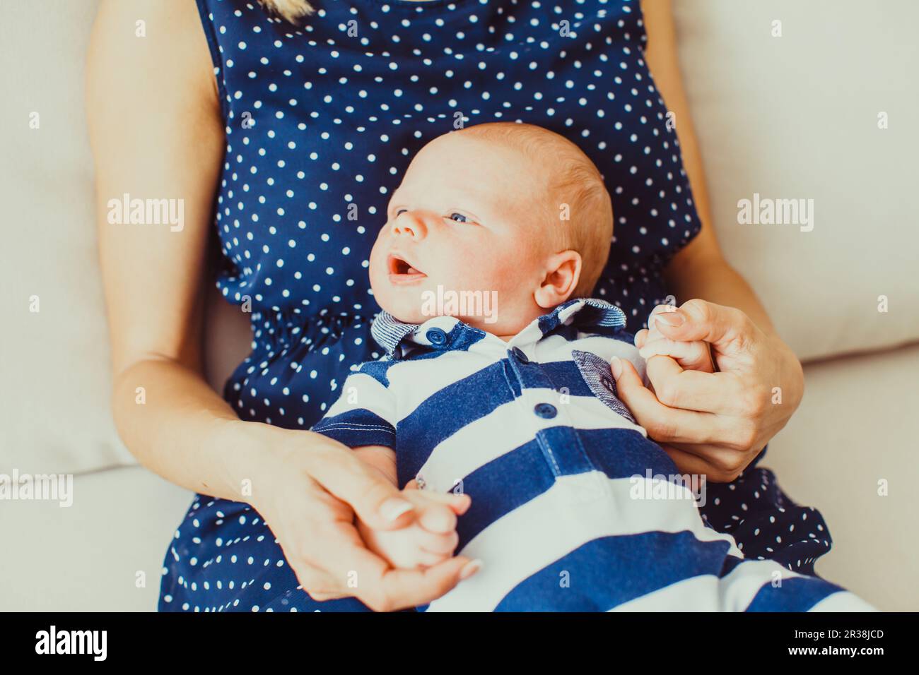Portrait of an adorable baby in a stripped clothing Stock Photo - Alamy