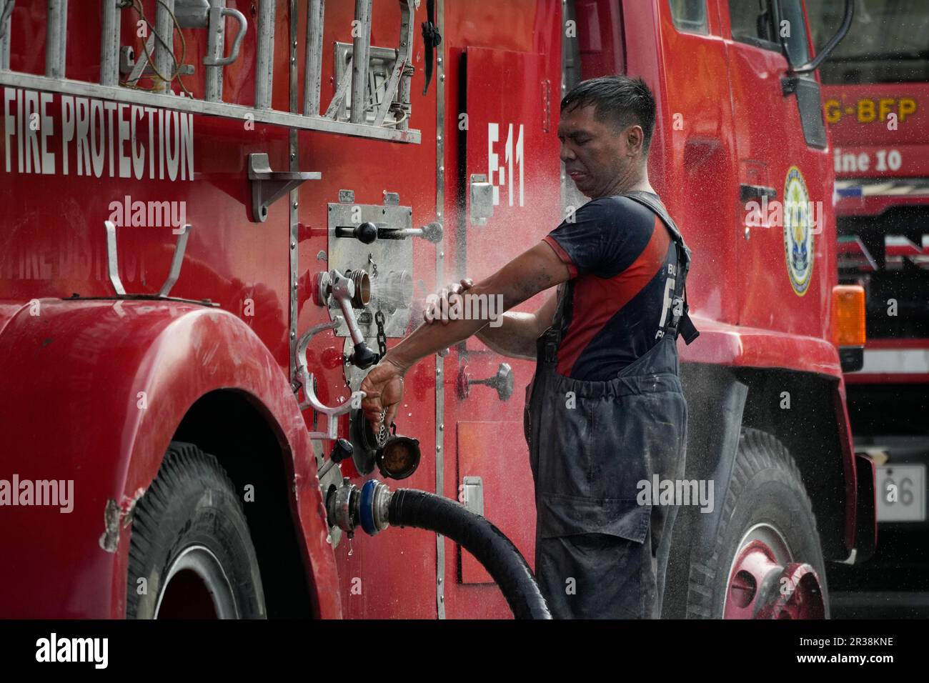Fireman's Post A fireman cleans himself after working inside the burned Manila Central ...