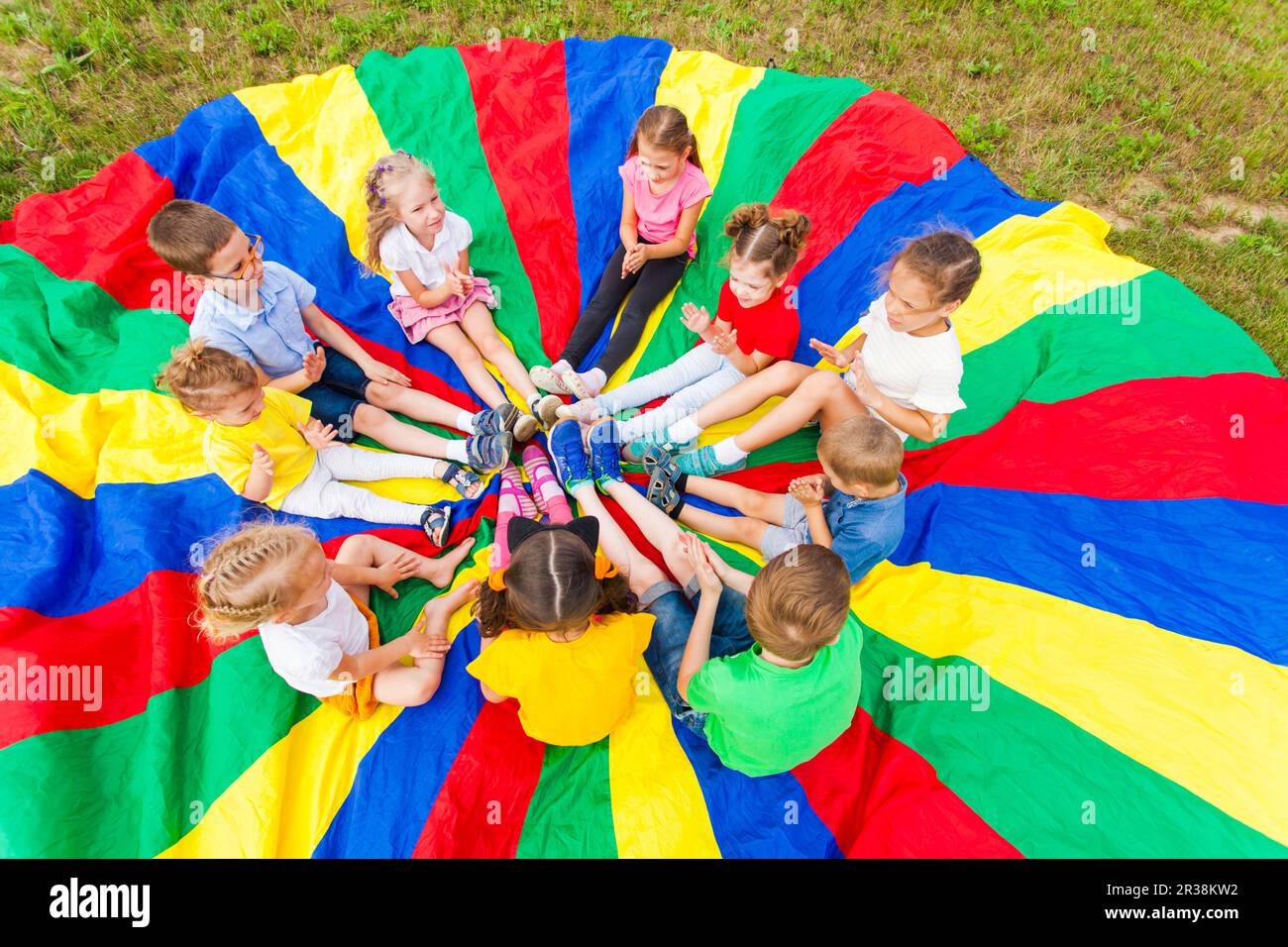 Group of kids on the lawn in the summer outdoors Stock Photo
