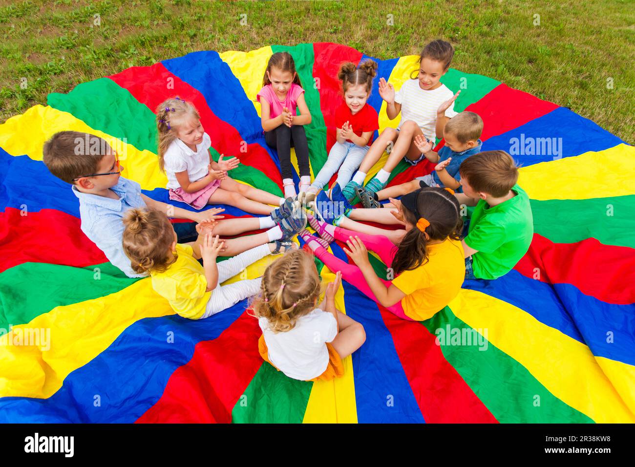 Kids clap the hands in the summer outdoors Stock Photo