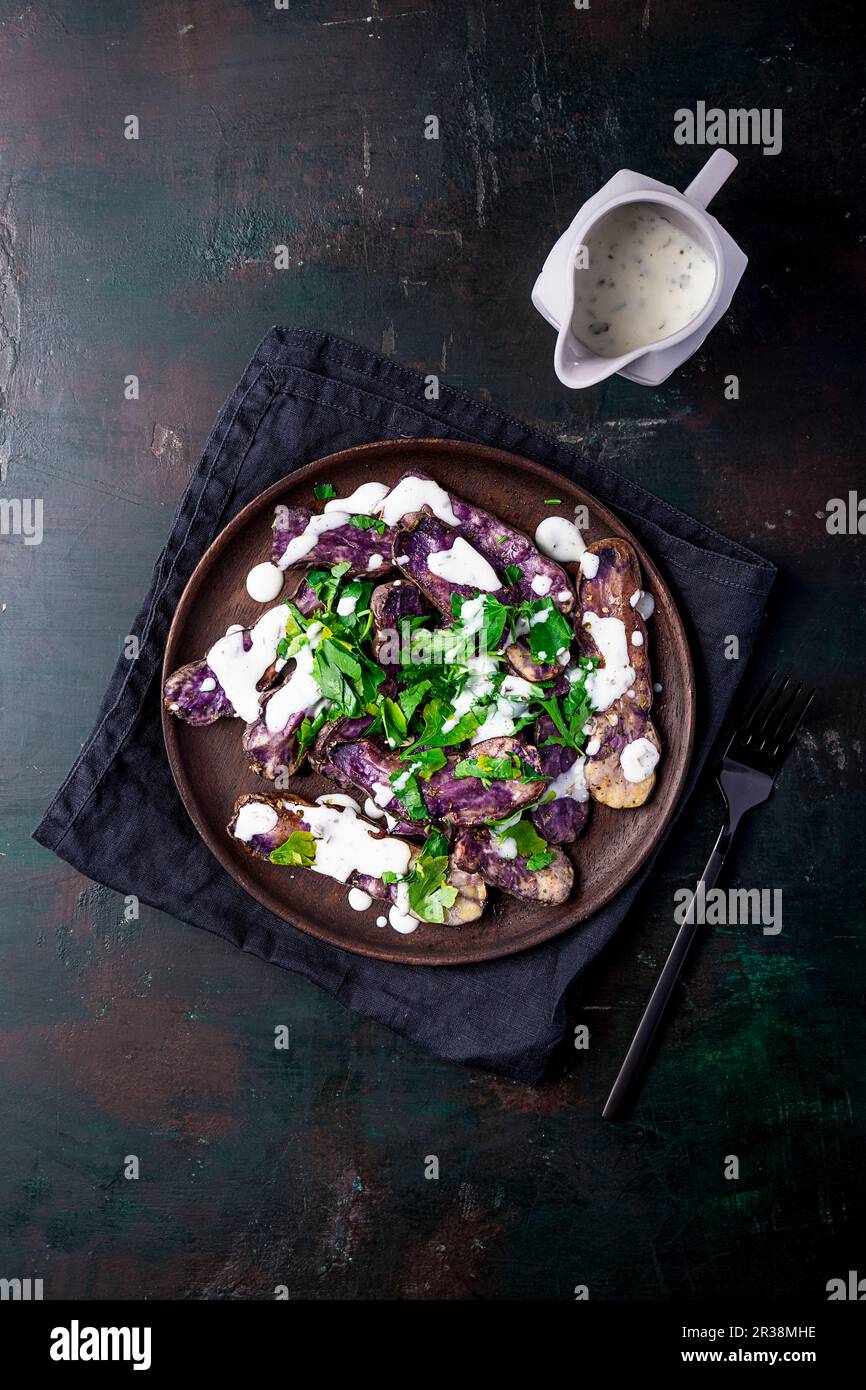 Blue potato and parsley salad with yoghurt dressing Stock Photo Alamy