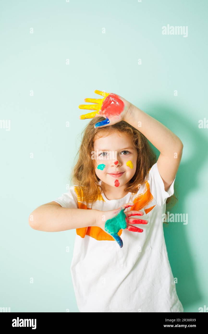 Portrait of cute girl with painted face and hands Stock Photo - Alamy