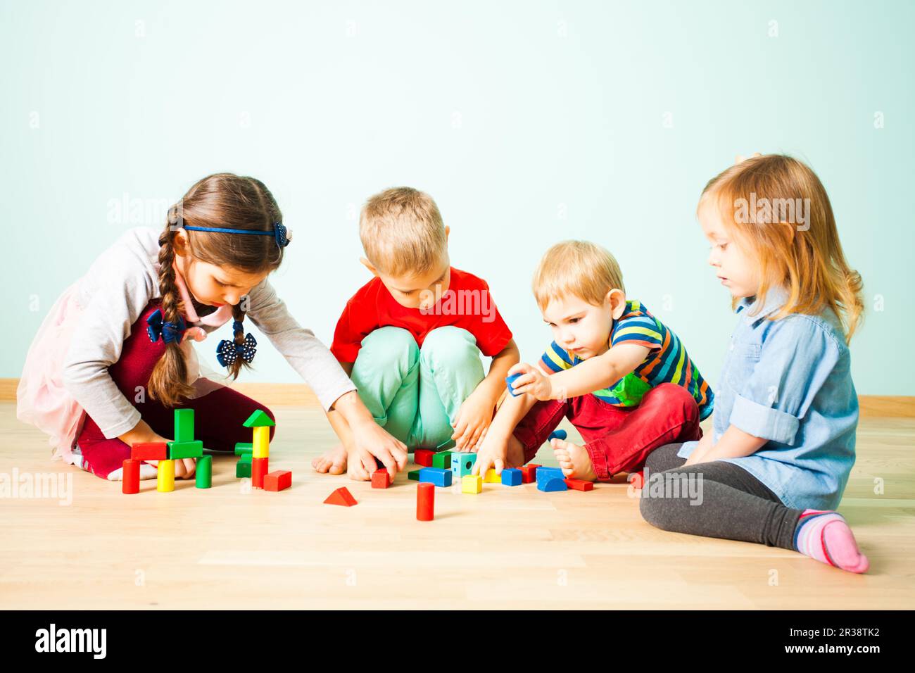 Kids playing with wooden blocks at kindergarten Stock Photo Alamy