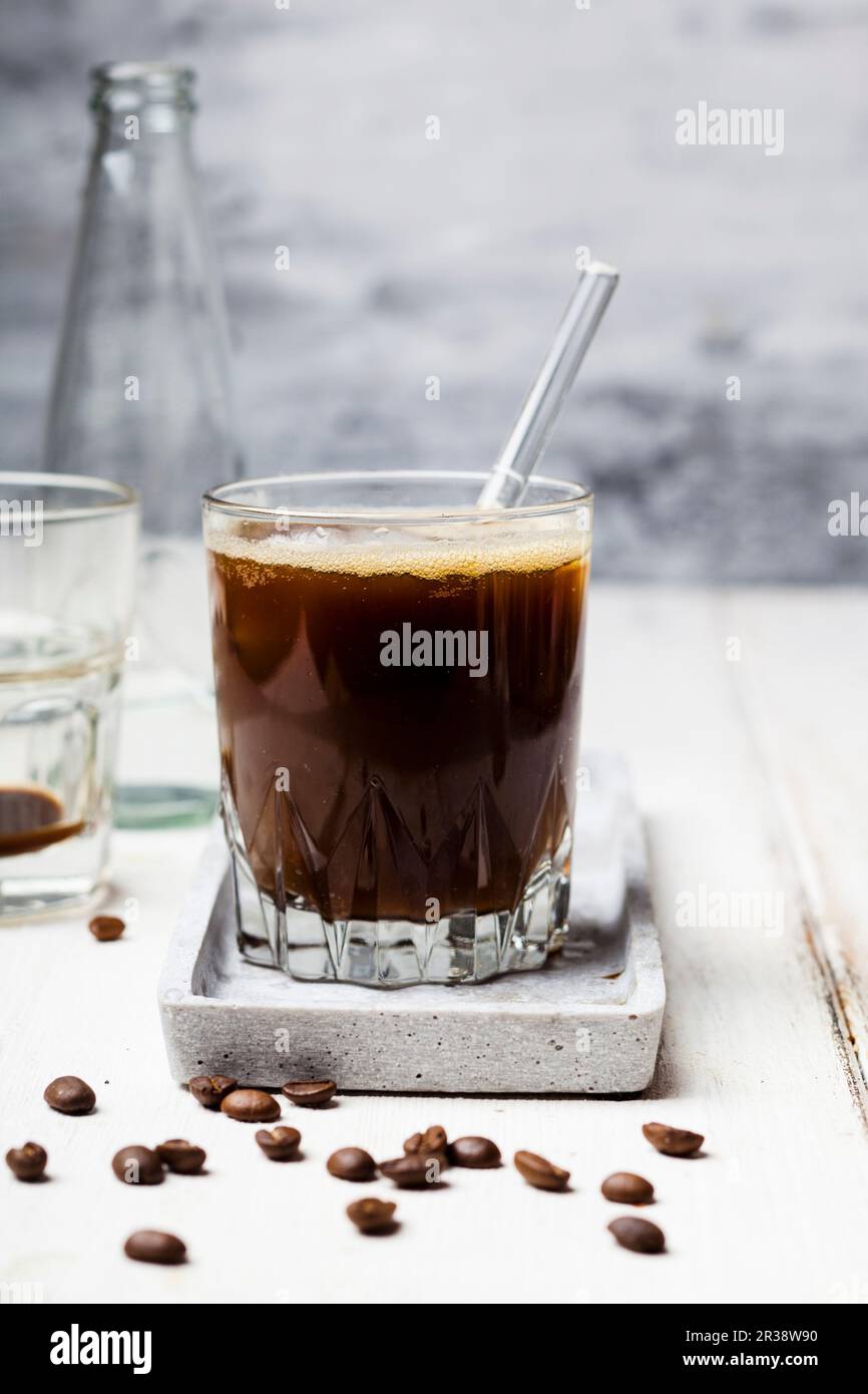 Espresso with sparkling water and ice cubes Stock Photo Alamy