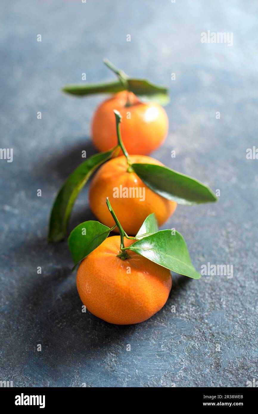 Mandarins on a stone surface, close up Stock Photo