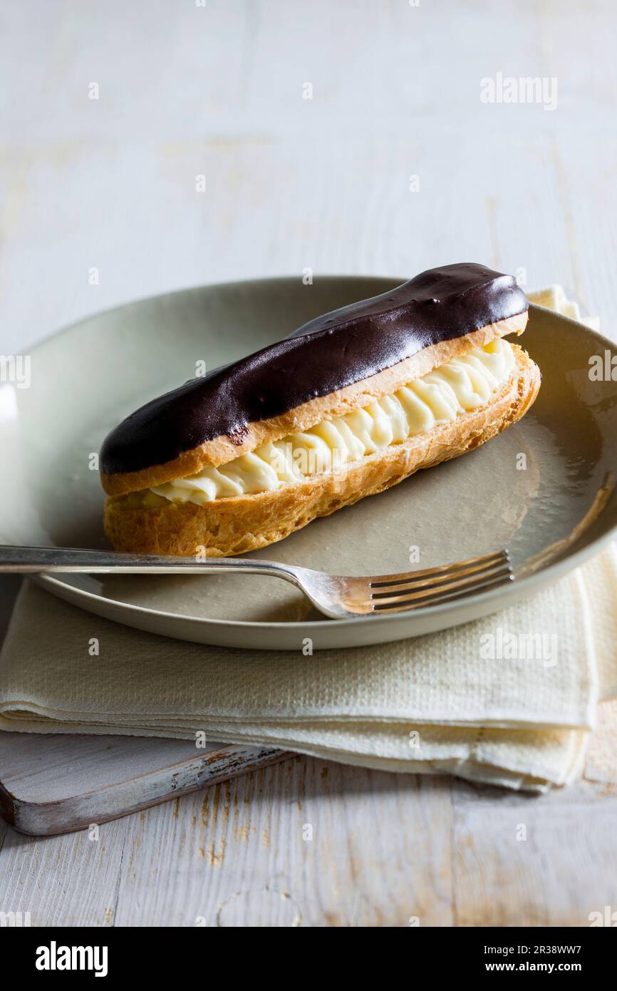Eclair with chocolate icing Stock Photo