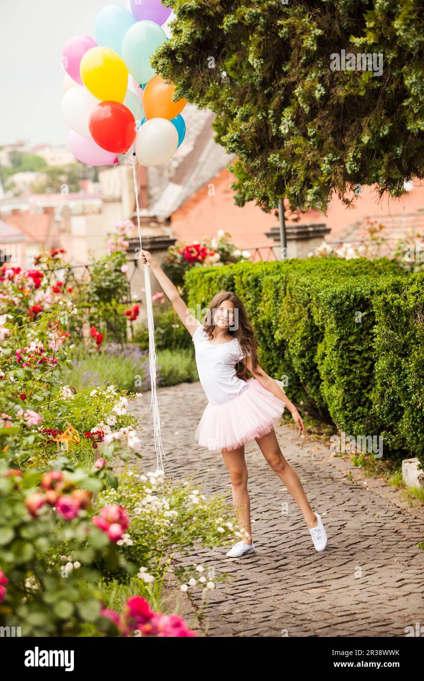 Girl with colorful latex balloons in the park Stock Photo - Alamy