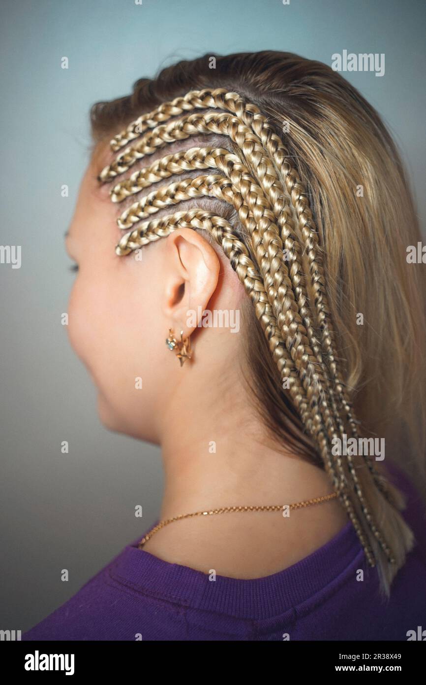 Cornrows Brades on the temple for the girl blondes Stock Photo