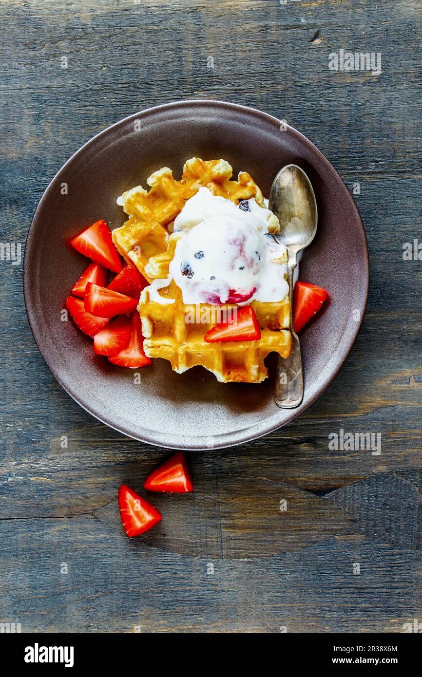 Belgian waffles with strawberries and ice cream (seen from above Stock ...