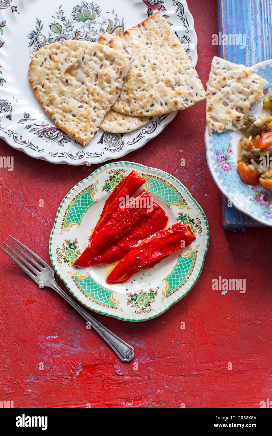 Unleavened bread, roasted peppers and mutabal Stock Photo