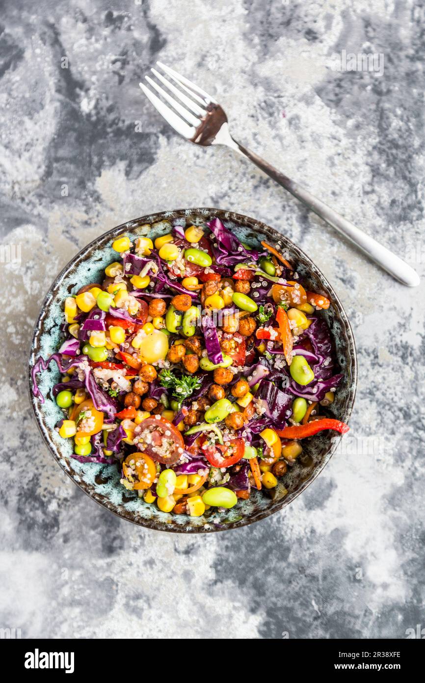 Colourful quinoa salad with tomatoes, sweetcorn, edamame, red cabbage