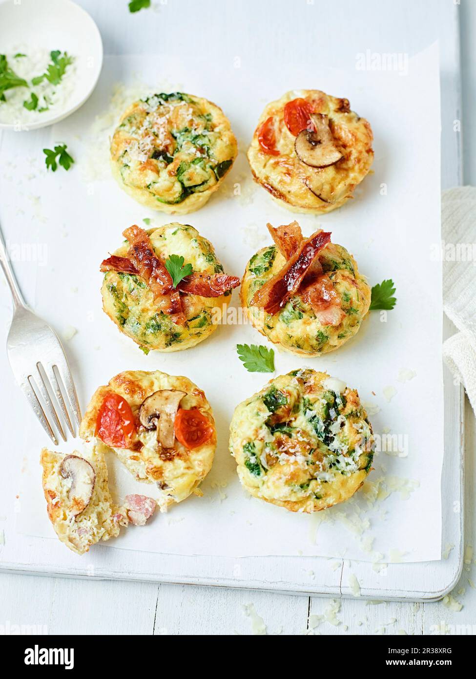 Frittata muffins with bacon, tomatoes, mushrooms and zucchini Stock