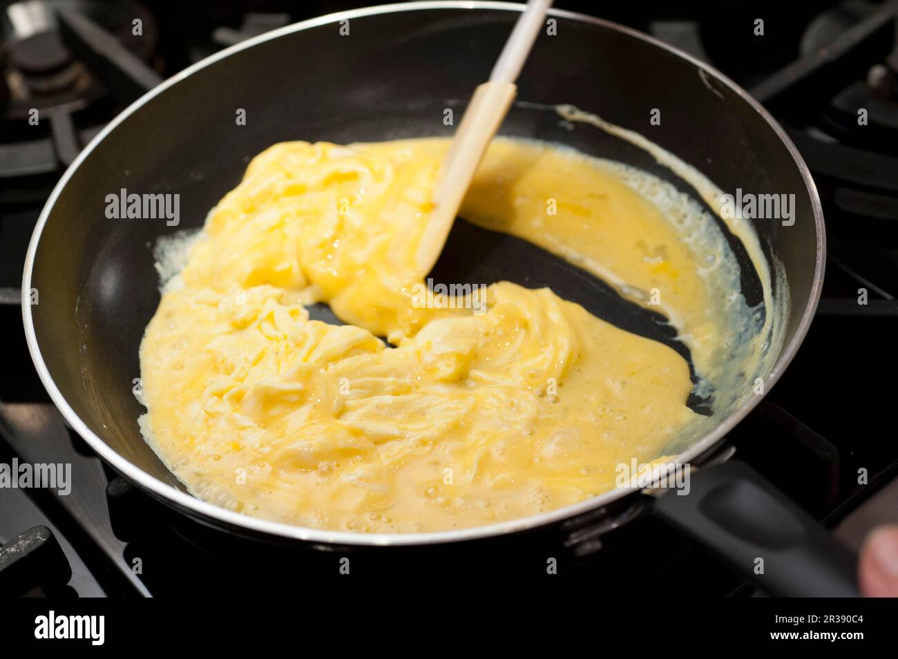 Preparing scrambled eggs in a pan Stock Photo - Alamy