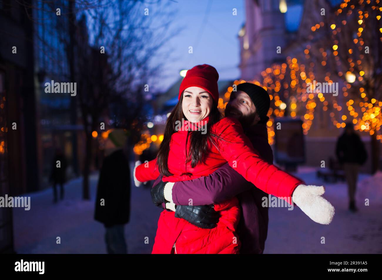 Marry couple standing in bright lights outdoors Stock Photo