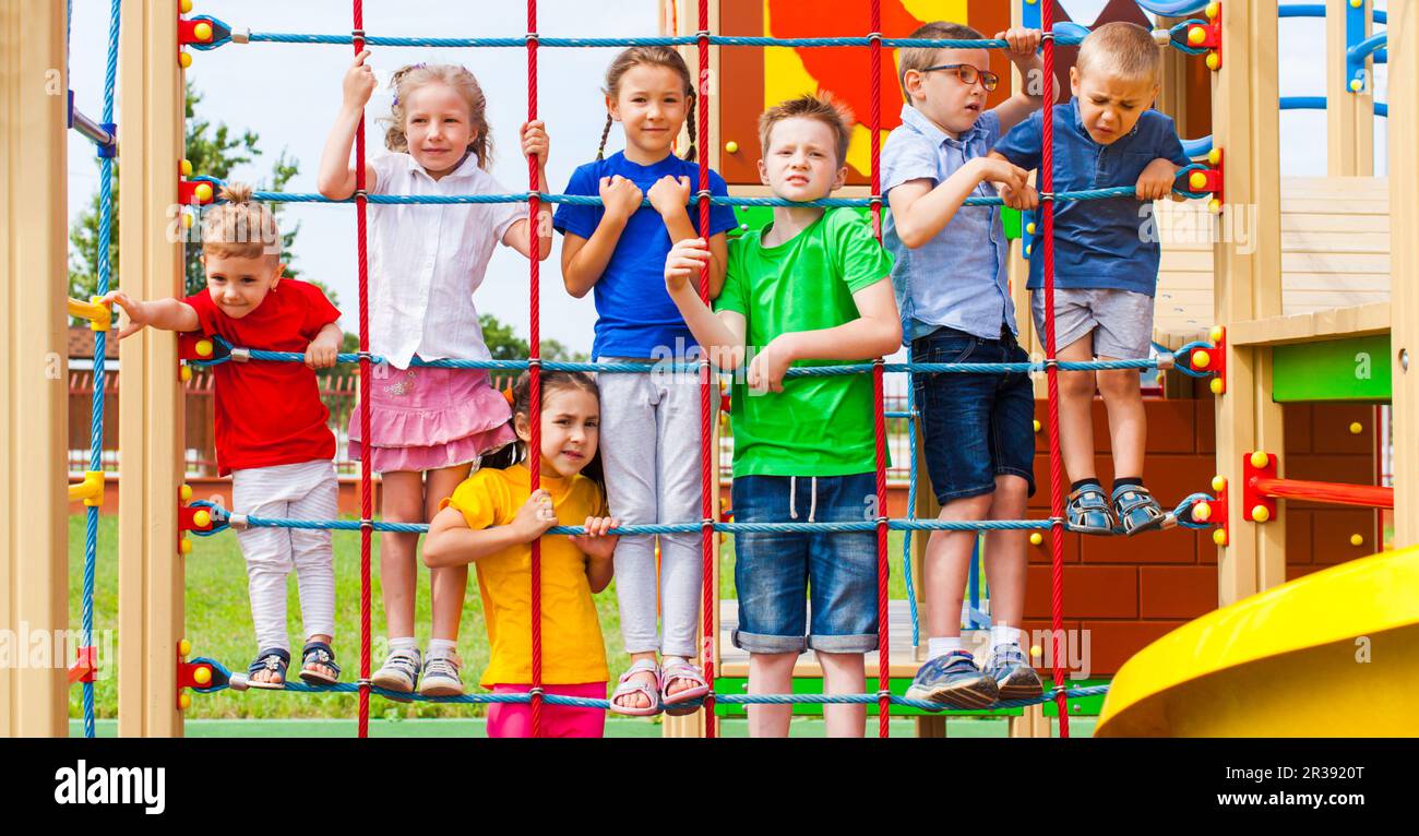Playful time outdoors on playground with rope net Stock Photo