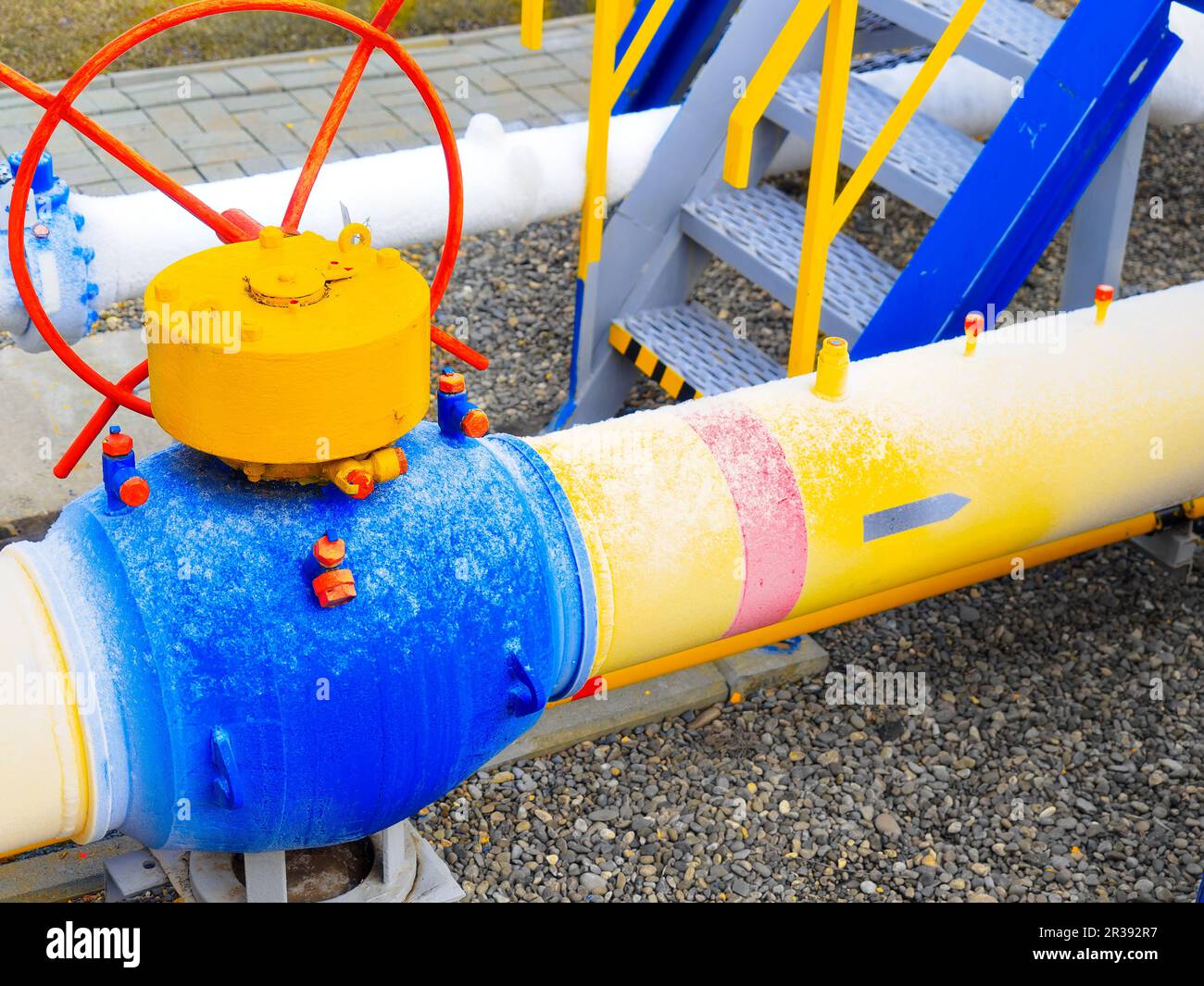 Icing of gas pipes at gas distribution station. Yellow pipe with tap