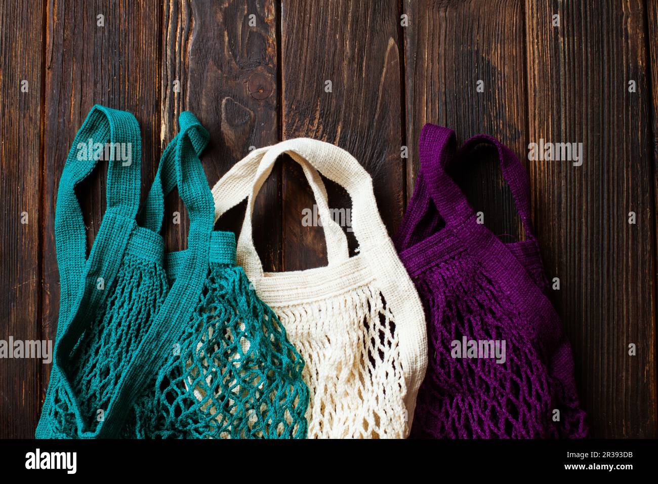 Variety colors of cotton eco mesh bag on the table Stock Photo