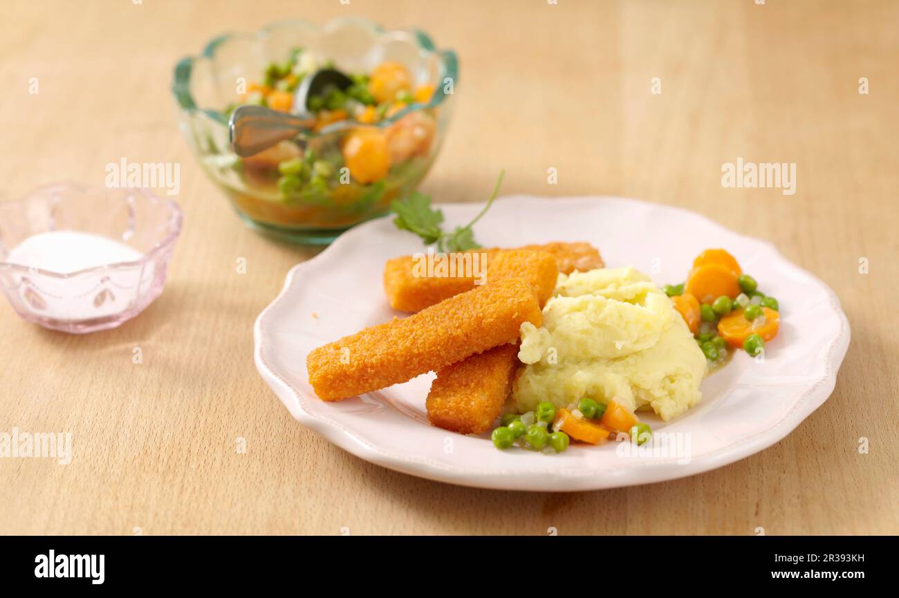Fish fingers and mashed potatoes with a pea and carrot medley Stock