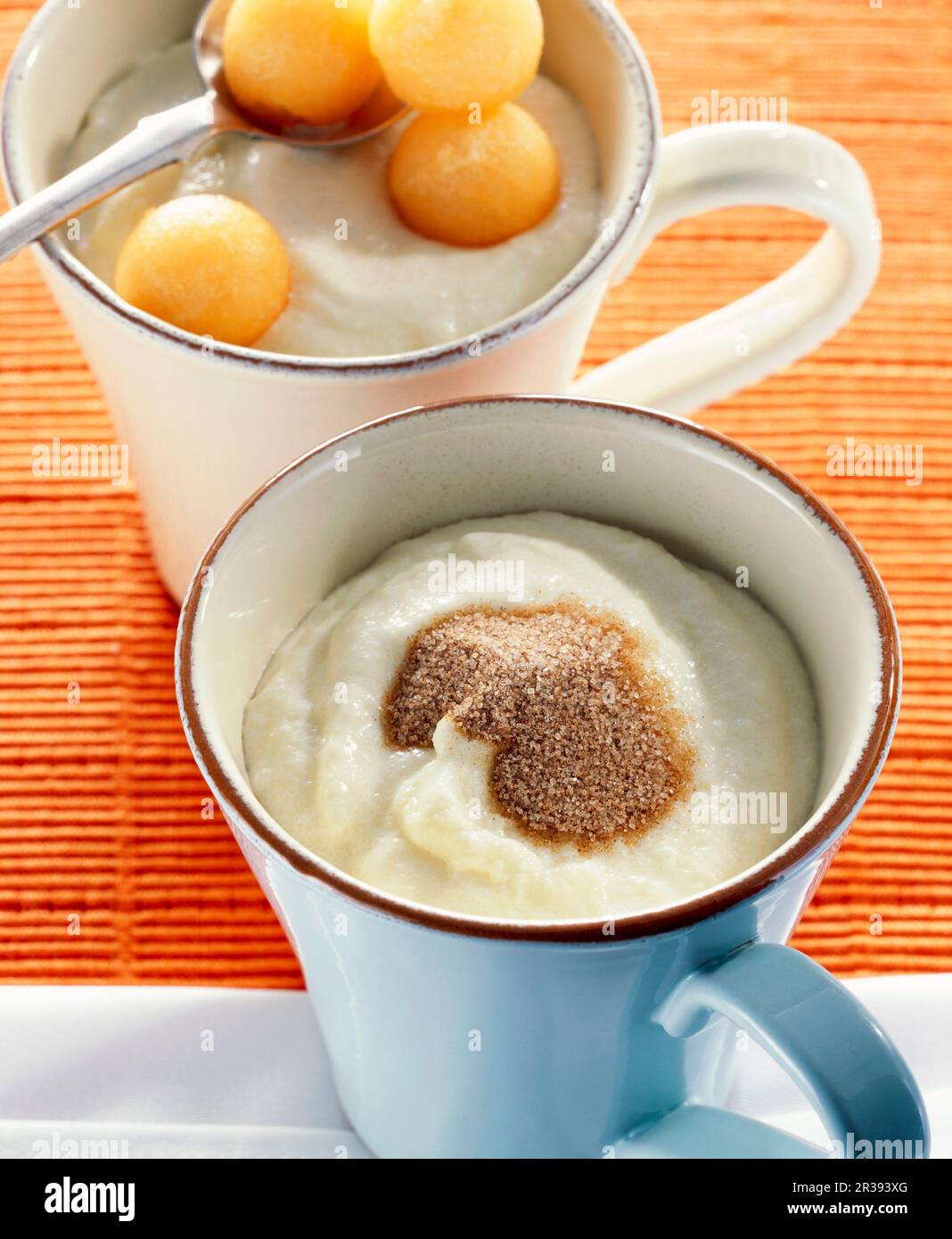 Semolina pudding with cinnamon sugar and melon balls Stock Photo