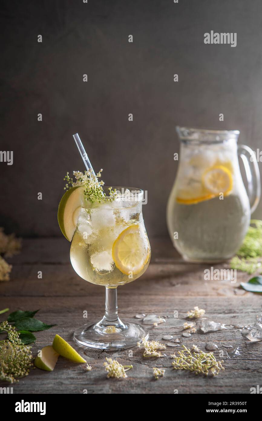 Elderflower cordial with lemon and apple slices on ice Stock Photo