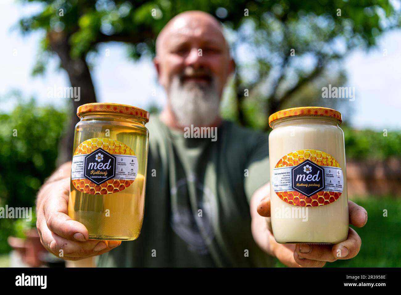 Trebivlice, Czech Republic. 22nd May, 2023. Beekeeper Ales Pelikan shows jars with honey in Trebivlice, Litomerice region, Czech Republic, May 22, 2023. The beekeeper estimates that there will be less spring honey year-on-year due to cooler weather. He expects a slight increase in price due to higher costs. Credit: Ondrej Hajek/CTK Photo/Alamy Live News Stock Photo