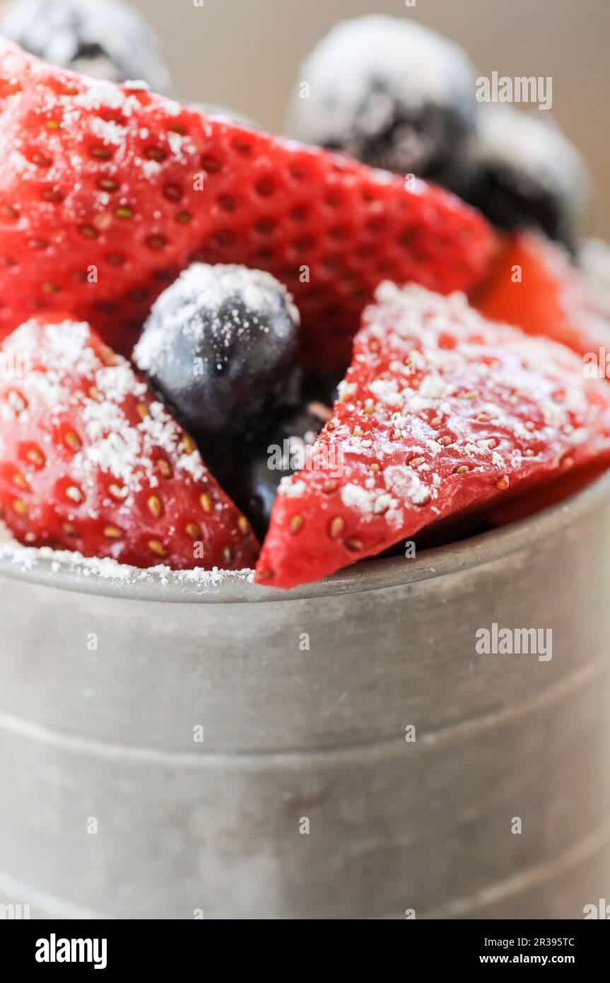 Strawberries and blueberries with powdered sugar Stock Photo - Alamy