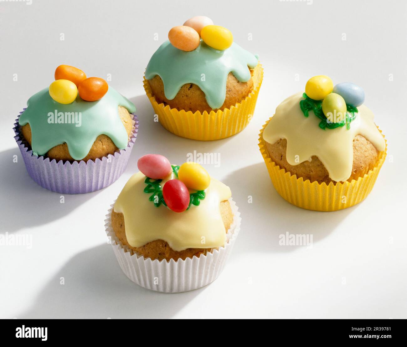 Colourful Easter muffins with icing and sugar eggs Stock Photo