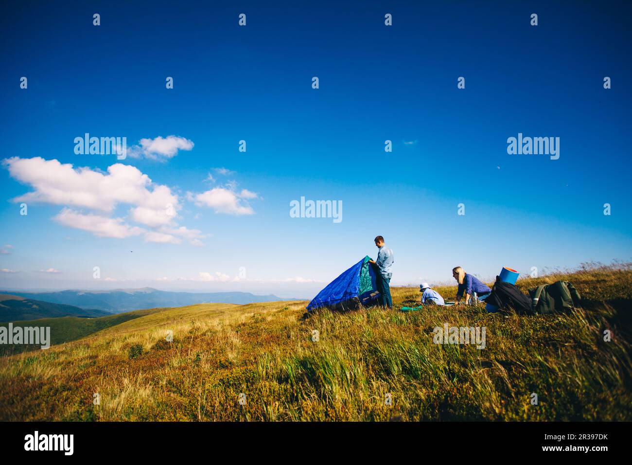 Young Family Relaxing On Camping Holiday in mountains Stock Photo