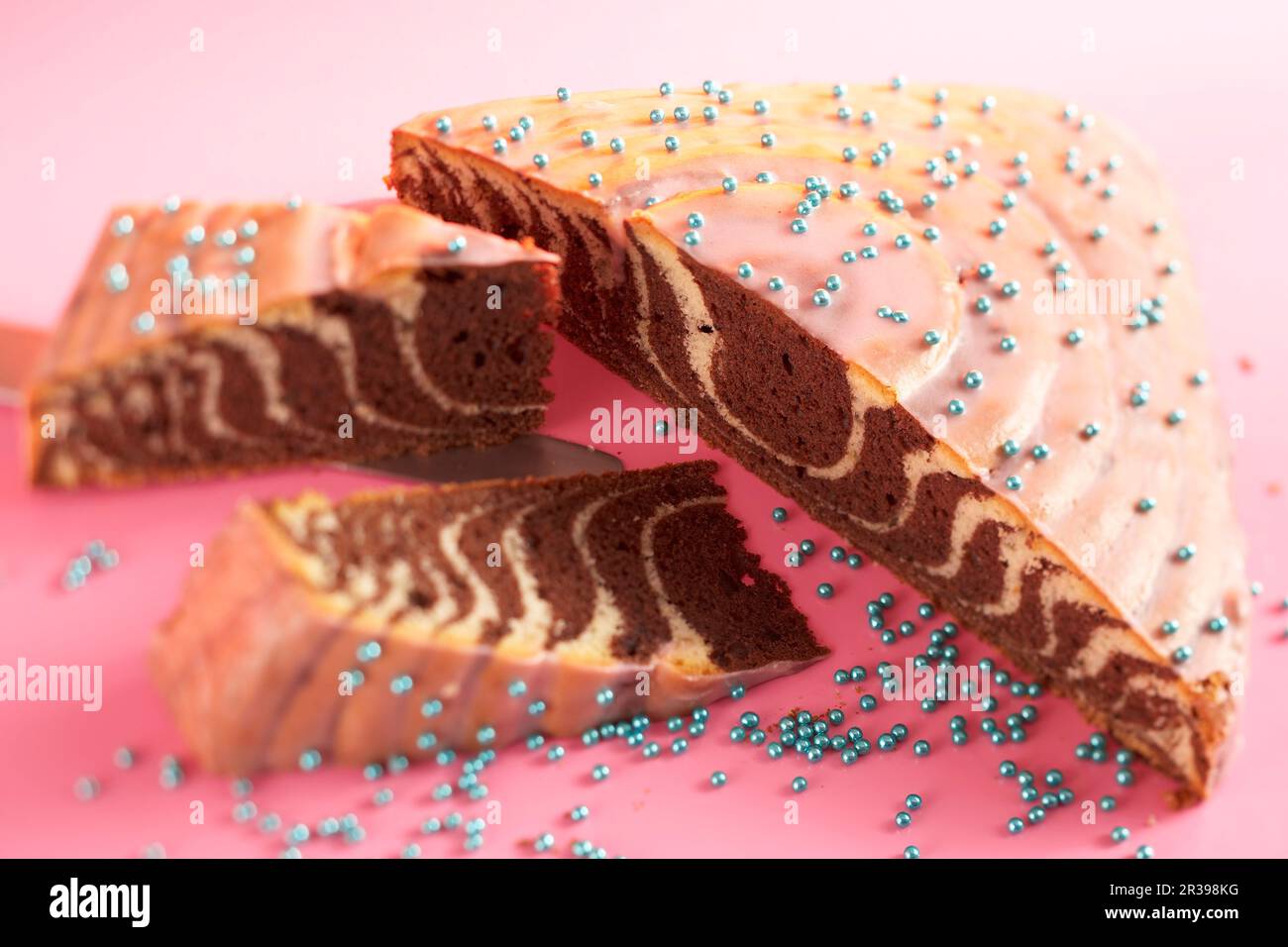 Christmas zebra cake with orange and pink icing Stock Photo Alamy