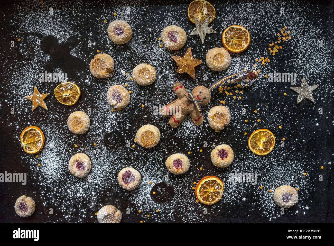 Shortbread jam biscuits with orange slices, stars and a Christmas figure Stock Photo