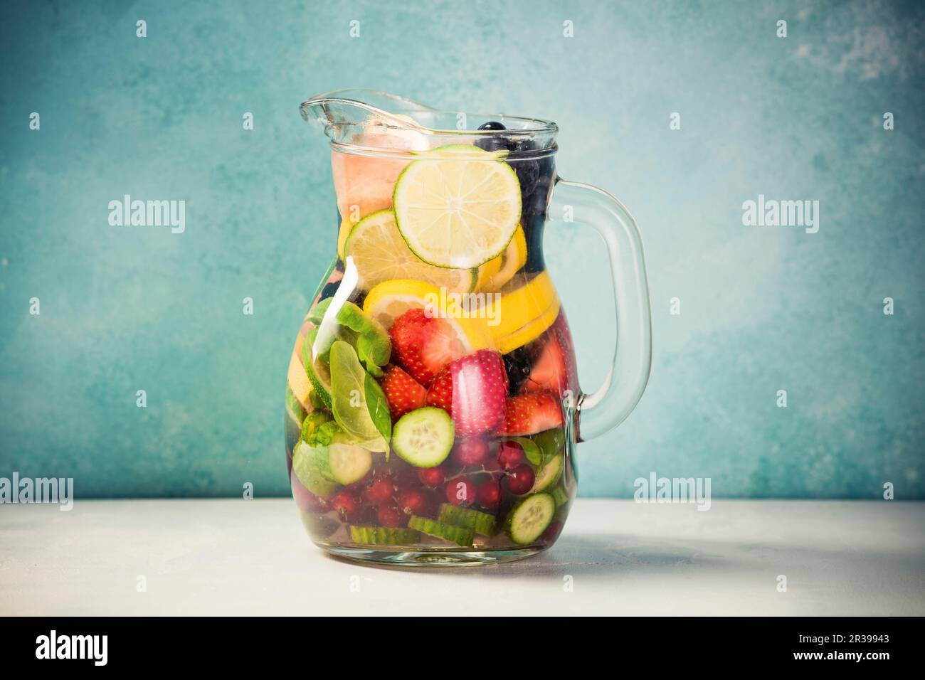 Infused water with fresh organic fruits and berries Stock Photo