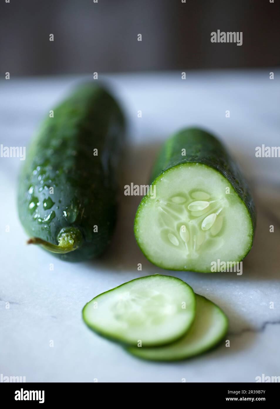 Whole and Sliced Kirby Cucumbers on a Marble Surface Stock Photo Alamy