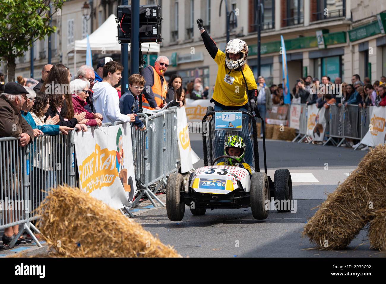 Second edition of a soapbox race in the heart of the city center of Crépy-en-Valois. Homemade soap box hurtling down the slope of the main street. Stock Photo