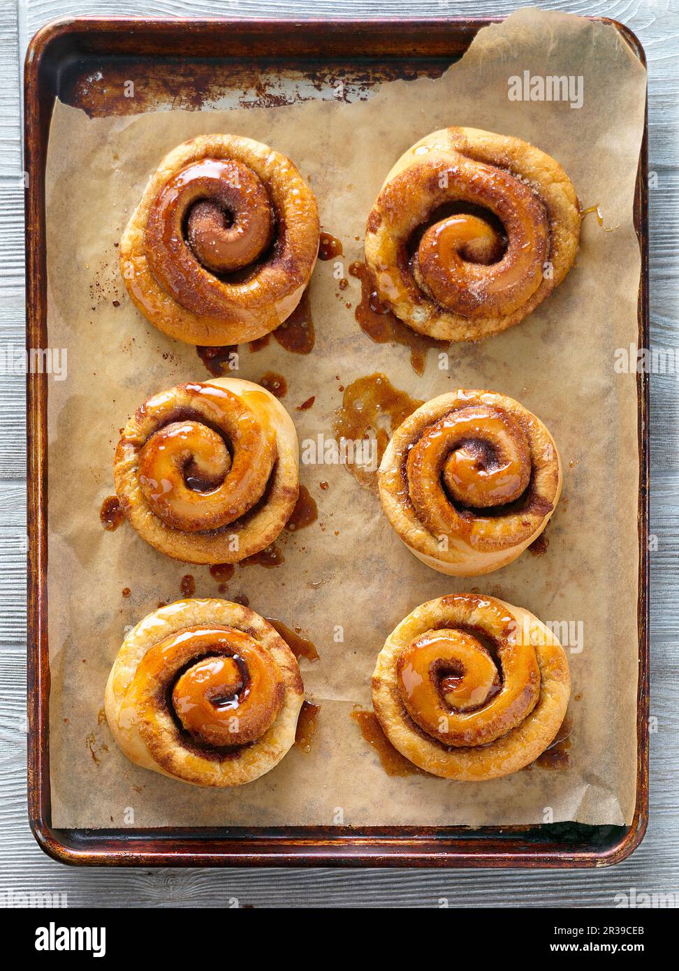 Cinnamon buns on a baking tray (seen from above) Stock Photo