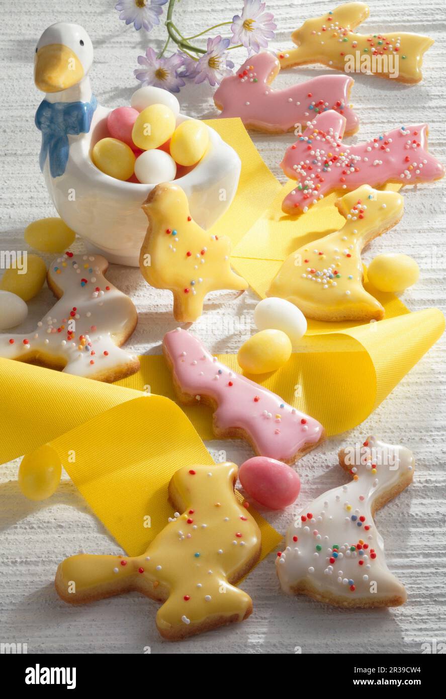 Colourful Easter biscuits with yellow ribbon and Easter eggs Stock Photo